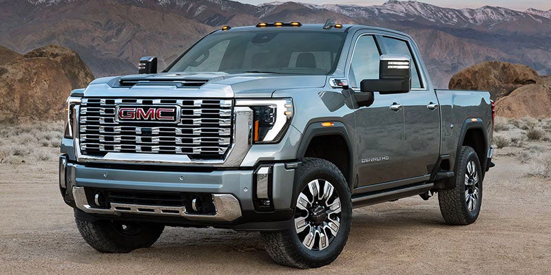 Side profile of 2025 Sierra 2500 HD in rugged terrain